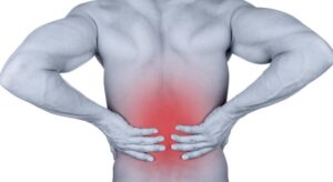Picture of a man holding his back with a red area of low back pain