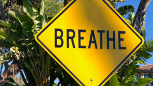 Yellow road sign reading "Breathe"