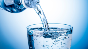 Bottle pouring water in to glass